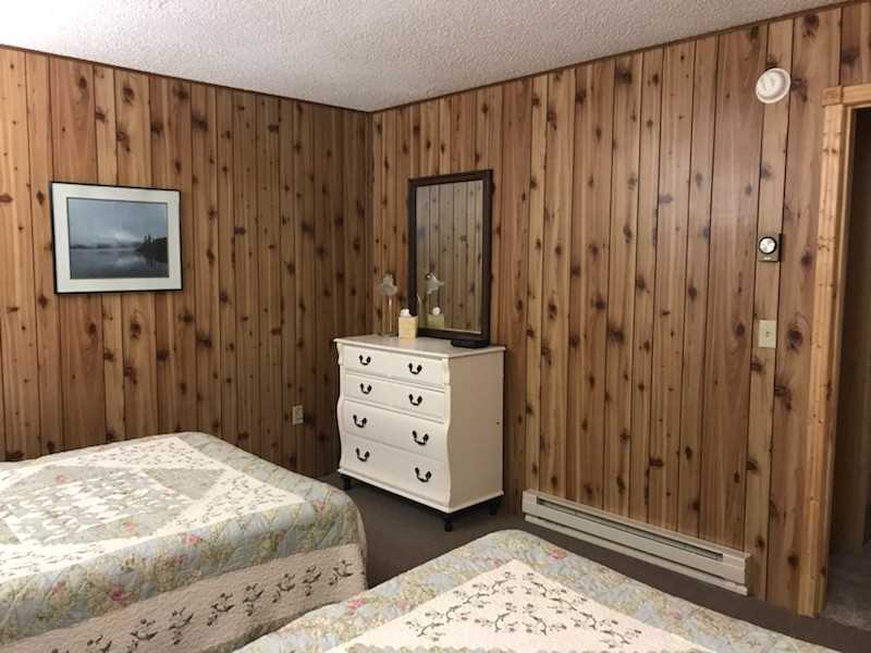 North Bedroom With Dresser and Queen and Full Beds
